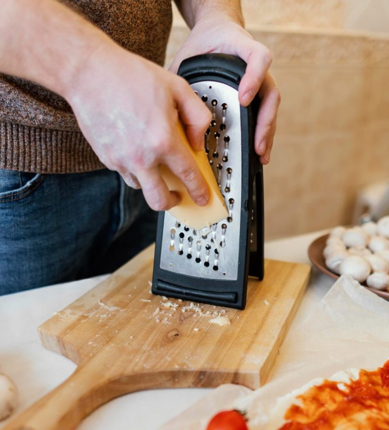 Designed by Freepik - https://www.freepik.com/free-photo/close-up-hand-grating-cheese_13106744.htm#fromView=search&page=1&position=7&uuid=d51fb15f-d7b1-48e5-84cd-6bb643e55446